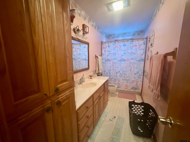 bathroom featuring curtained shower, vanity, a textured ceiling, and toilet