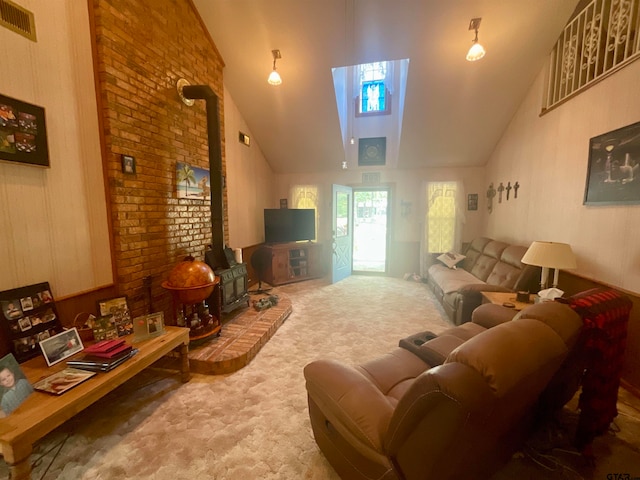 carpeted living room with high vaulted ceiling, a wealth of natural light, and a wood stove