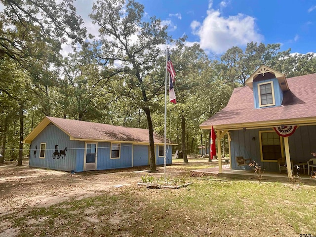 back of property featuring a lawn