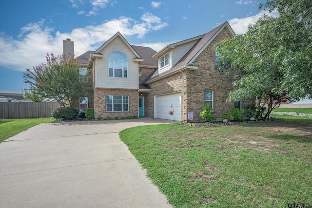 view of front of home with a front yard and a garage