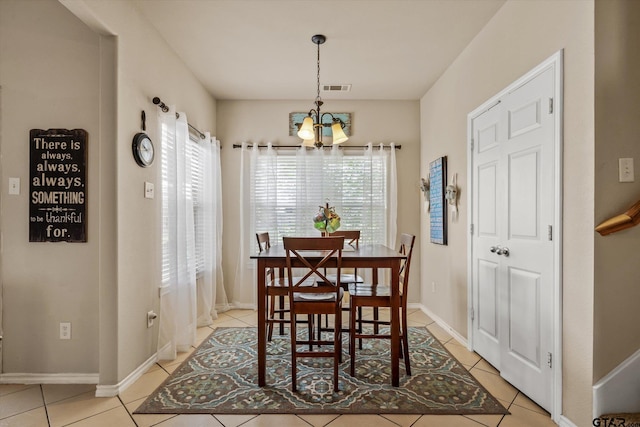 dining space featuring plenty of natural light, a notable chandelier, and light tile patterned flooring