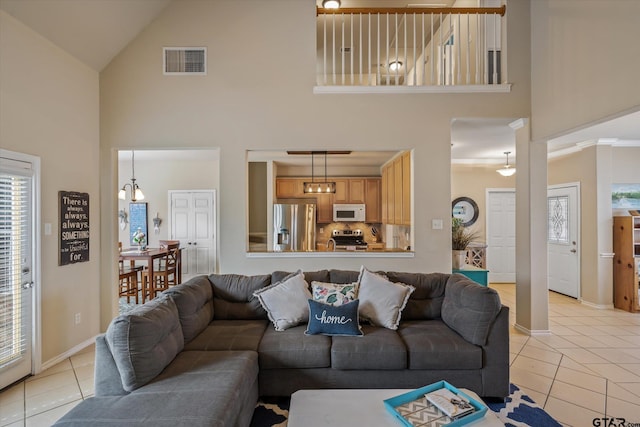 living room featuring light tile patterned floors and high vaulted ceiling