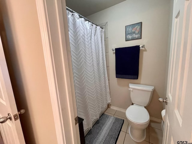 bathroom with tile patterned flooring and toilet