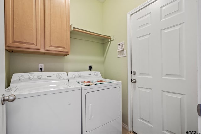 laundry room with cabinets and washing machine and clothes dryer