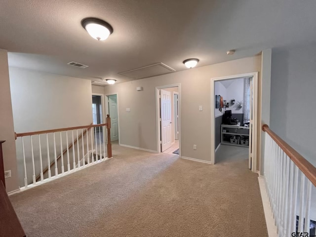 carpeted empty room with a textured ceiling