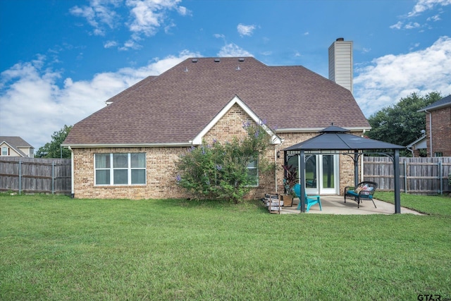 back of property featuring a gazebo, a yard, and a patio area