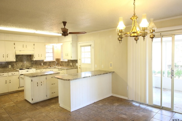 kitchen featuring a center island, ceiling fan with notable chandelier, hanging light fixtures, a textured ceiling, and white cabinetry