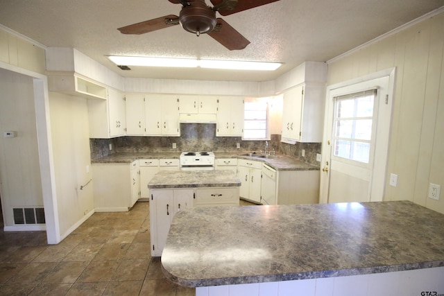 kitchen featuring white cabinetry, a center island, white appliances, and sink