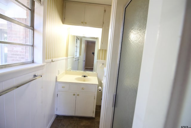 bathroom with a shower with door and vanity