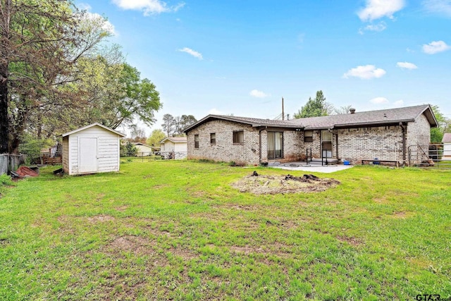 rear view of house featuring a yard, a patio, and a shed