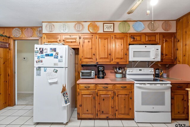 kitchen featuring white appliances and a textured ceiling