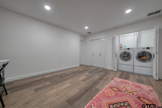 washroom featuring visible vents, laundry area, recessed lighting, wood finished floors, and washer and dryer