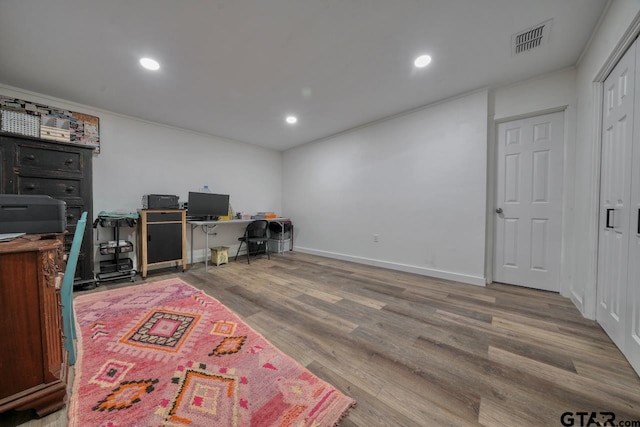 office featuring visible vents, wood finished floors, recessed lighting, crown molding, and baseboards