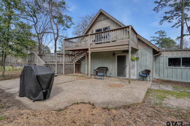 back of property featuring a patio, board and batten siding, a deck, and stairs