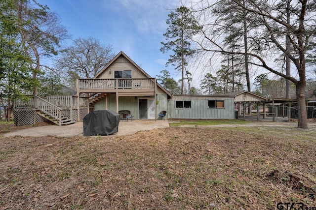 back of house featuring stairs, a patio, and a deck