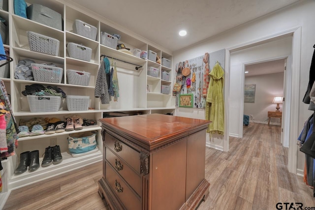 walk in closet with light wood-type flooring