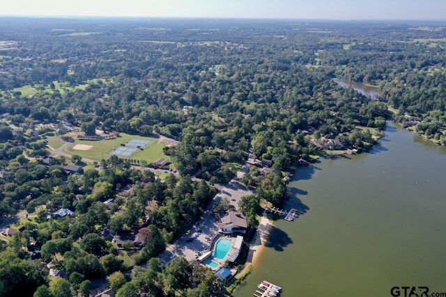 birds eye view of property with a wooded view and a water view