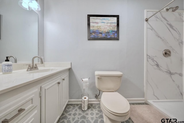 full bathroom with a marble finish shower, toilet, vanity, and baseboards