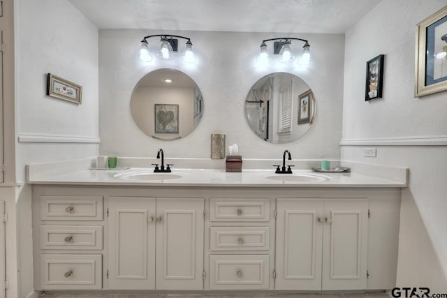 bathroom featuring double vanity and a sink