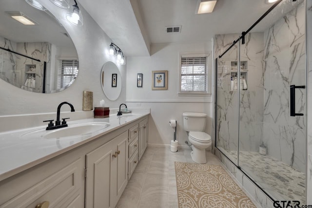 bathroom with visible vents, a marble finish shower, and a sink