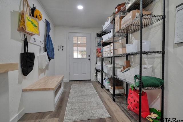 mudroom featuring baseboards and wood finished floors