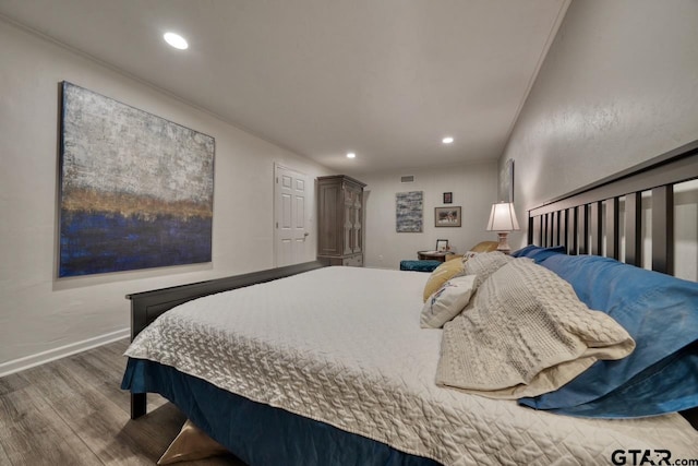 bedroom featuring visible vents, recessed lighting, baseboards, and wood finished floors