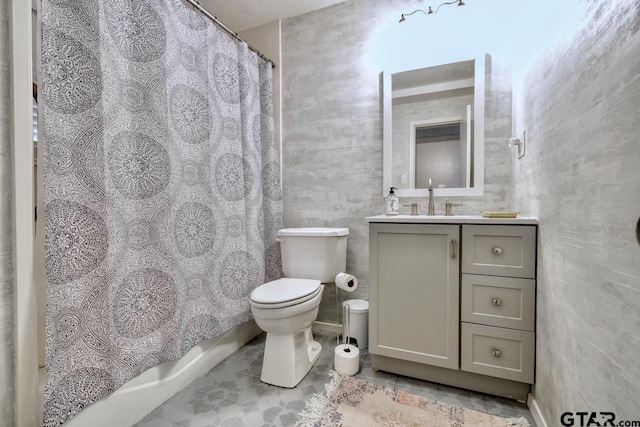 bathroom featuring tile patterned floors, toilet, and vanity