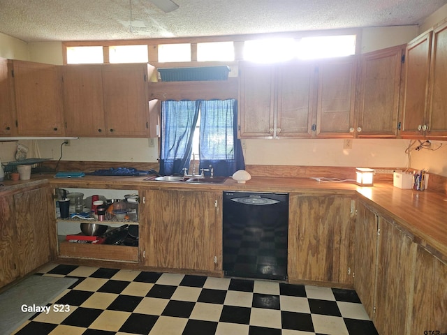 kitchen with sink, a textured ceiling, and black dishwasher