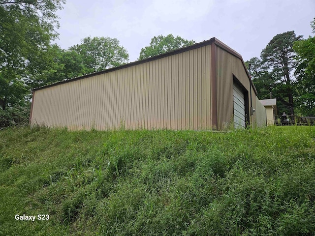 view of side of home featuring a garage and an outdoor structure