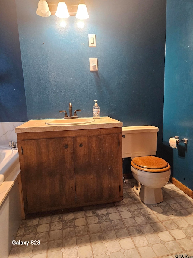 bathroom featuring tile patterned flooring, vanity, and toilet