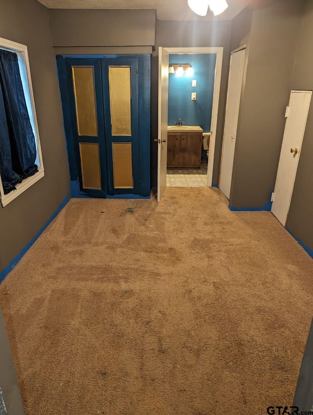 hall featuring light carpet