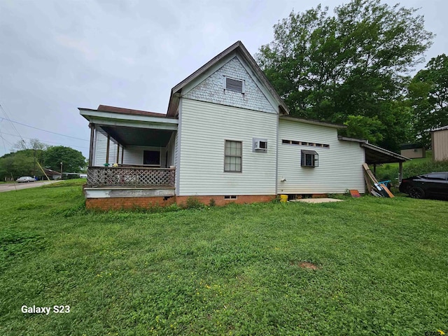 back of house with a lawn