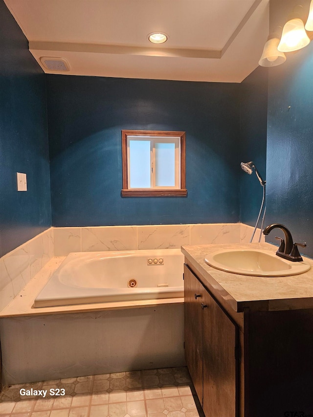 bathroom with vanity and a bathing tub