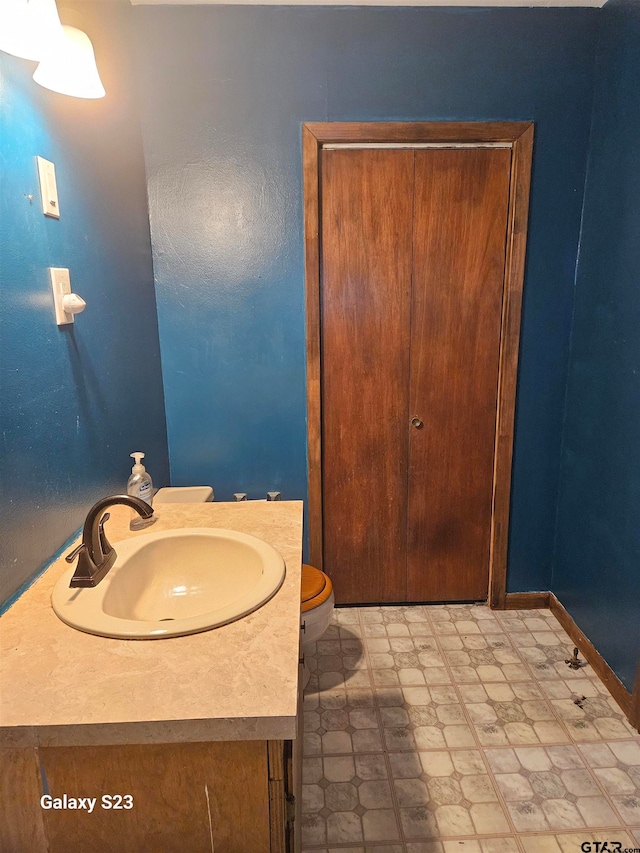 bathroom featuring vanity and toilet