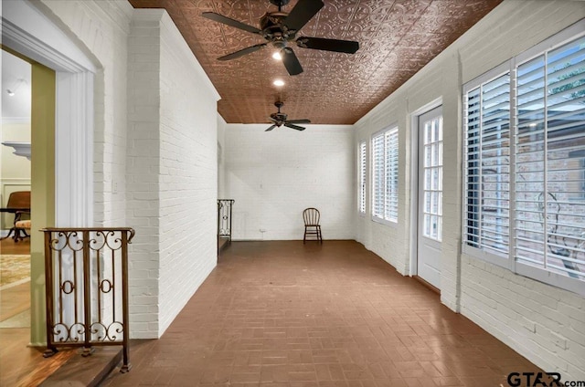 612 Rosemont Pl, Ii Place, Tyler, TX 75701 - unfurnished sunroom with brick wall, brick patterned floors, and an ornate ceiling