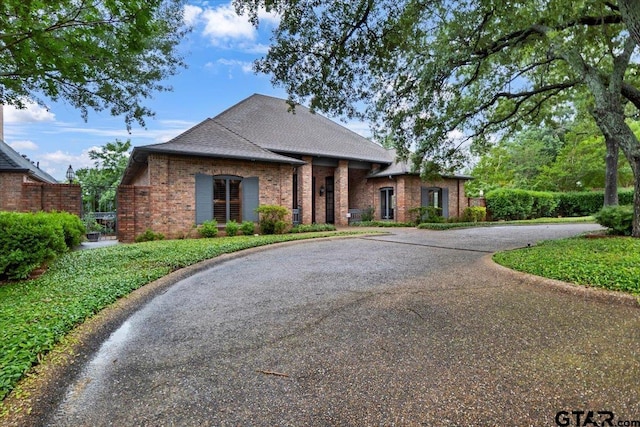 612 Rosemont Pl, Ii Place, Tyler, TX 75701 - view of front of property featuring brick siding, curved driveway, and a shingled roof