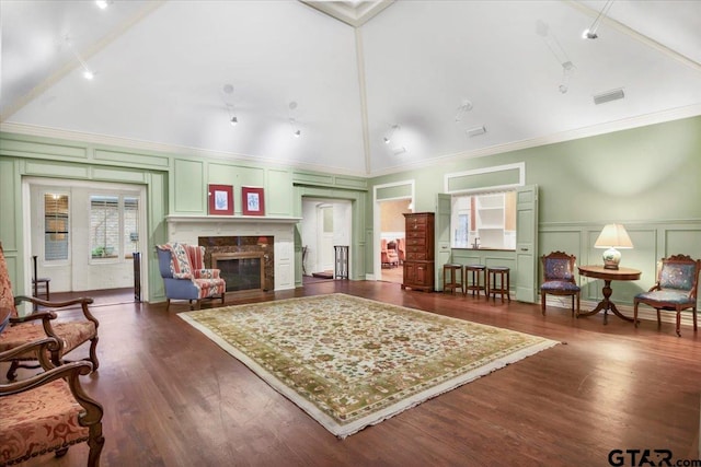 612 Rosemont Pl, Ii Place, Tyler, TX 75701 - living room with a decorative wall, dark wood-style floors, a premium fireplace, wainscoting, and crown molding
