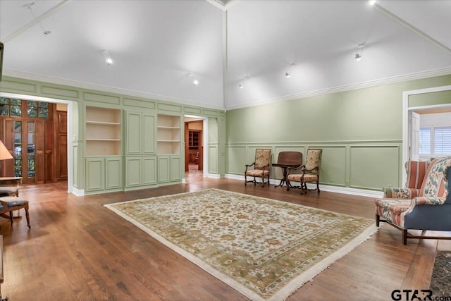 612 Rosemont Pl, Ii Place, Tyler, TX 75701 - living area featuring a decorative wall, crown molding, wood finished floors, lofted ceiling, and built in features