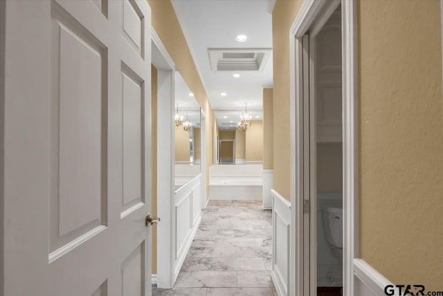 612 Rosemont Pl, Ii Place, Tyler, TX 75701 - hallway featuring a chandelier, a textured wall, light marble finish flooring, recessed lighting, and a wainscoted wall