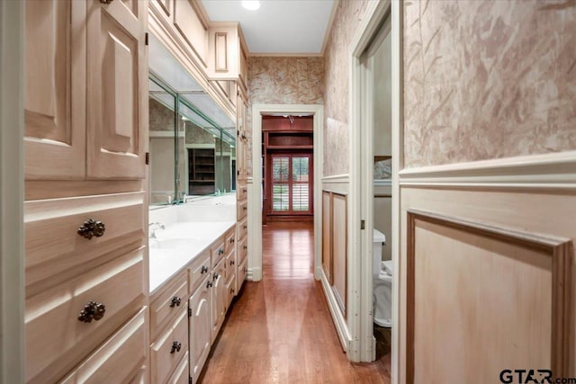 612 Rosemont Pl, Ii Place, Tyler, TX 75701 - bathroom with vanity, wood finished floors, wallpapered walls, and crown molding