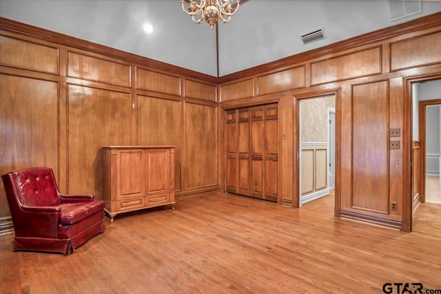 612 Rosemont Pl, Ii Place, Tyler, TX 75701 - unfurnished room with a decorative wall, light wood-style floors, and a chandelier
