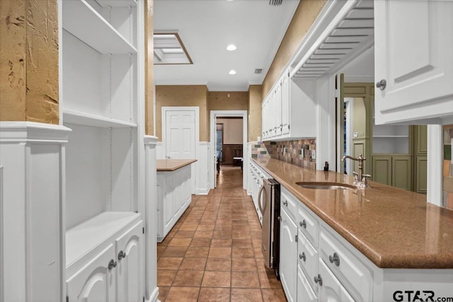 612 Rosemont Pl, Ii Place, Tyler, TX 75701 - kitchen featuring white cabinets, a wainscoted wall, backsplash, recessed lighting, and open shelves