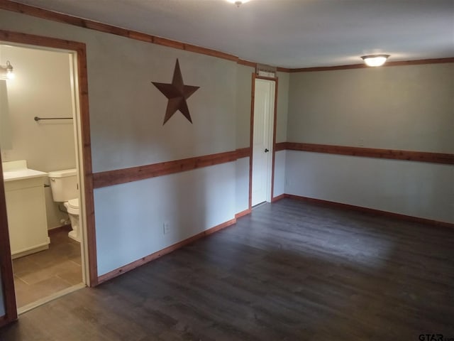 empty room featuring dark hardwood / wood-style flooring and crown molding