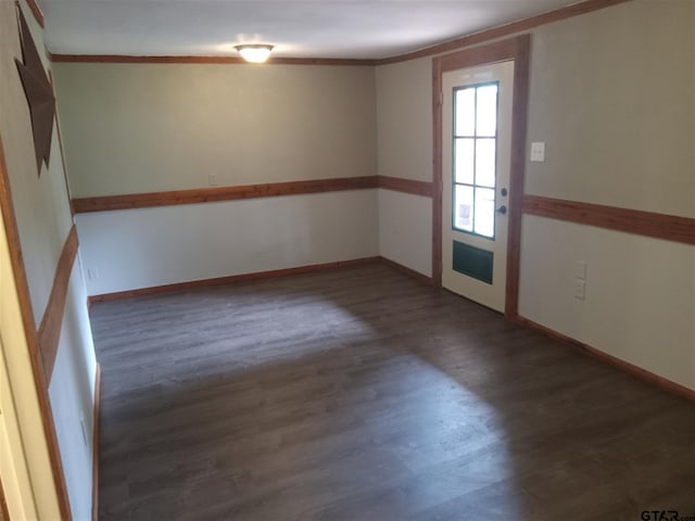 spare room featuring dark wood-type flooring