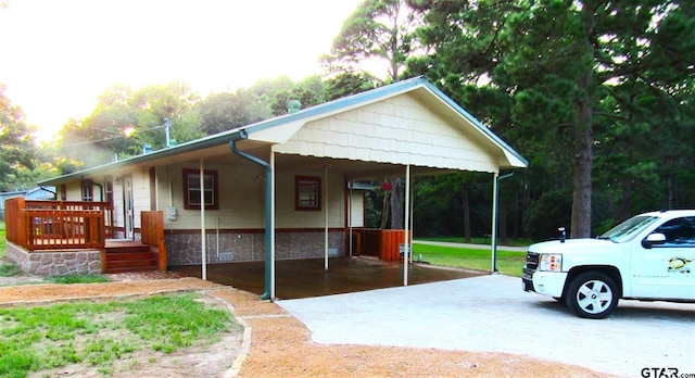 exterior space with covered porch and a carport