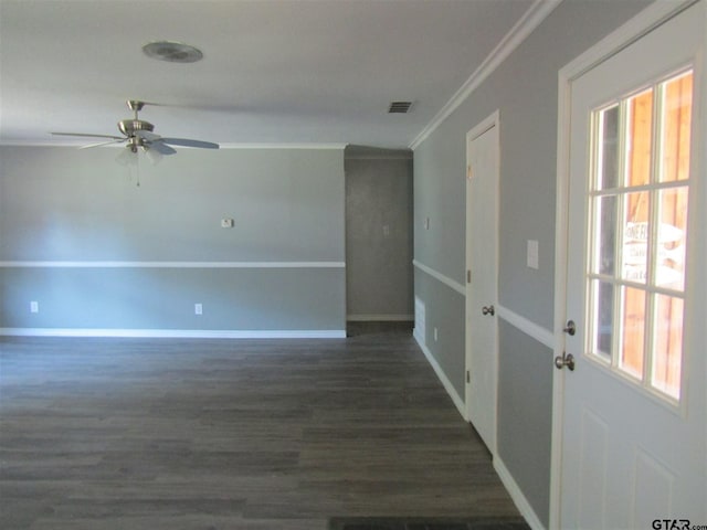 empty room with ceiling fan, dark hardwood / wood-style floors, and ornamental molding