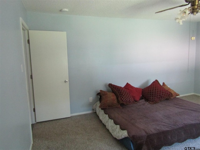 bedroom with a textured ceiling, light carpet, and ceiling fan