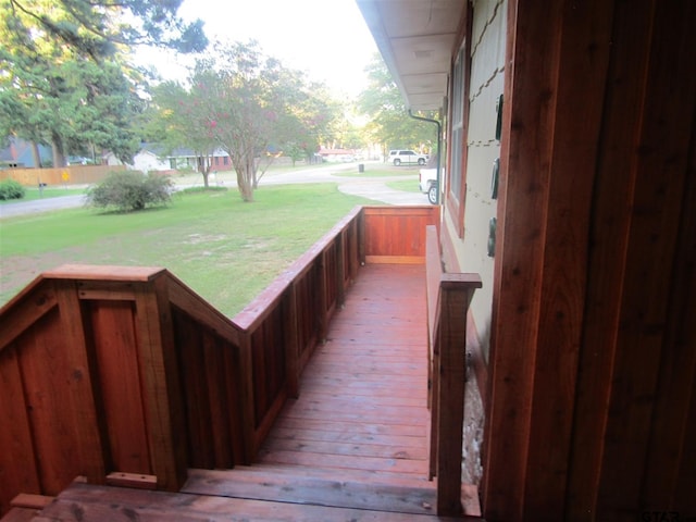 wooden deck with a lawn