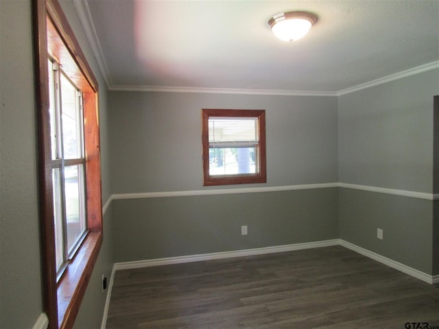 empty room with dark hardwood / wood-style flooring and ornamental molding