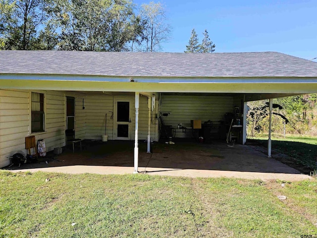 view of vehicle parking featuring a yard and a carport